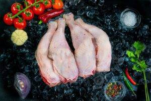 Chicken Legs 2 4 chicken legs on a bed of ice surrounded by veg and seasonings