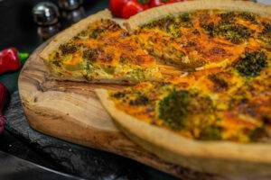 broccoli quiche on a wooden chopping board