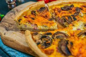 mushroom quiche on a wooden board