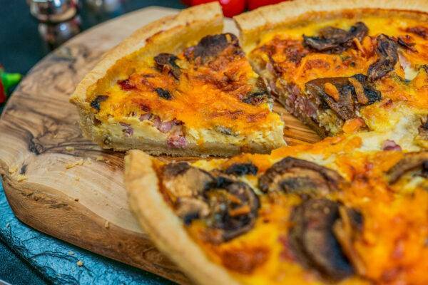 mushroom quiche on a wooden board