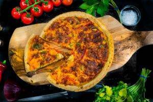 pepper quiche on a wooden board