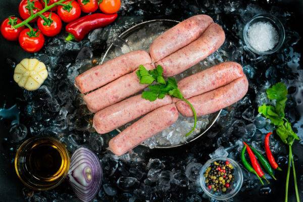 honey roast sausages on a bed of ice surrounded by veg and garnishes