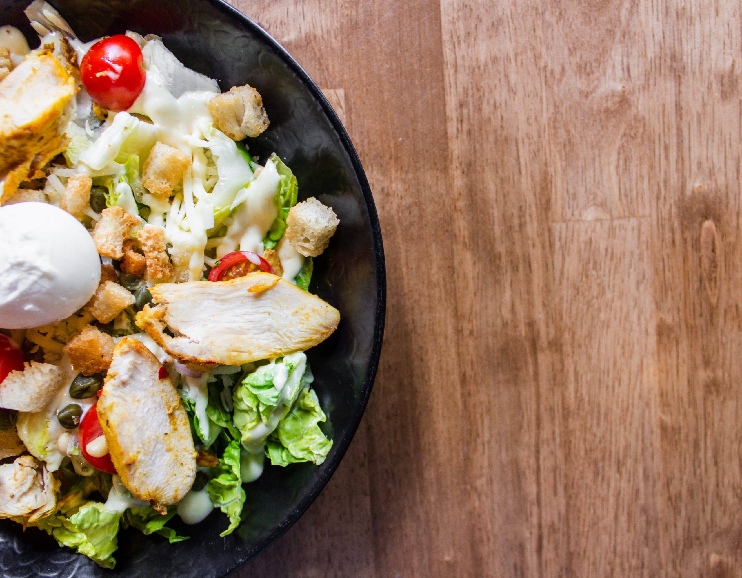 chicken salad in a black bowl