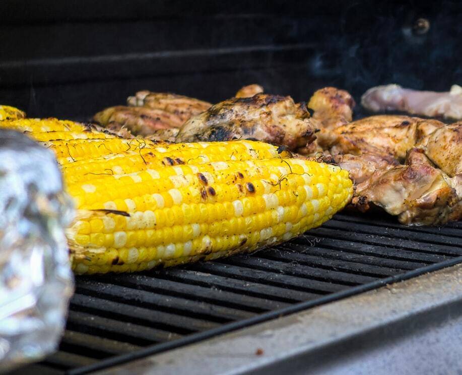 Chicken and corn on the cob on a BBQ