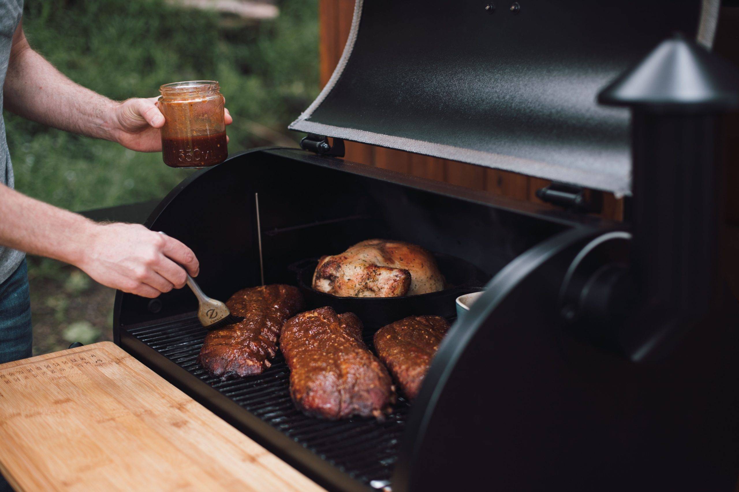 Meats on a BBQ being glazed