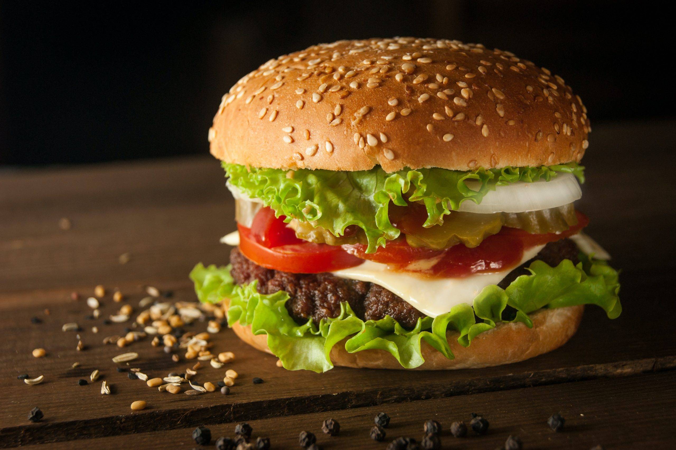 meat and cheese burger on sesame bun